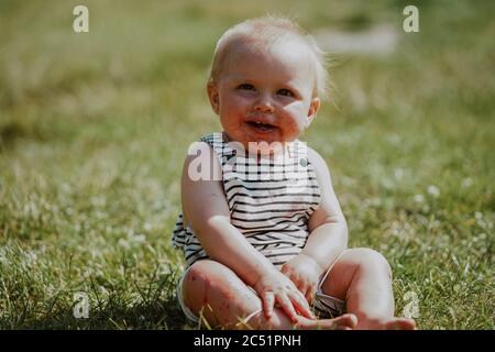 Baby boy raccolta di fragole in una fattoria nel Regno Unito Foto Stock
