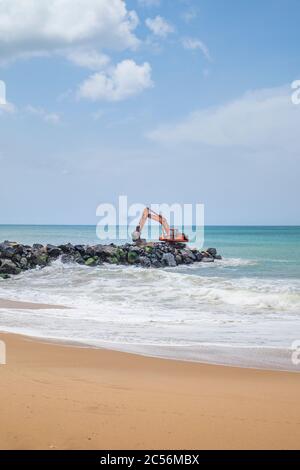 Escavatore su una scogliera sulla costa dello Sri Lanka Foto Stock