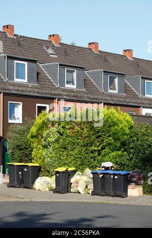 Edifici residenziali, separazione dei rifiuti, contenitori blu per carta di scarto, contenitori gialli per rifiuti di plastica, Brema, Germania, Europa Foto Stock