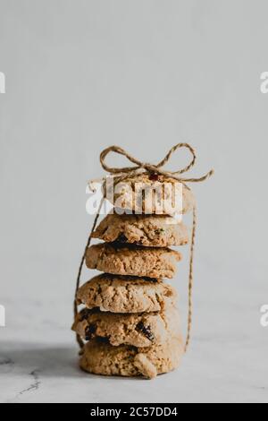 Una pila di biscotti di mirtillo di avena legati con un packthread Foto Stock