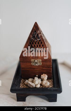 Un tradizionale fornello o bruciatore di frankincenso Omani, utilizzando lacrime di resina sacra di Boswellia, di provenienza locale, riscaldate in modo da emettere i loro aromi unici Foto Stock