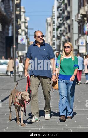 La coppia italiana camminando il proprio cane Weimaraner in Via Sparano da Bari. Bari, Italia Foto Stock