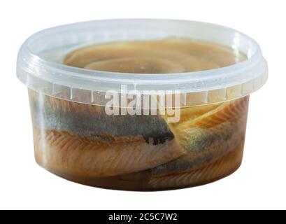 Filetto di aringa decapato in marinata di olio in contenitore di plastica. Isolato su sfondo bianco Foto Stock