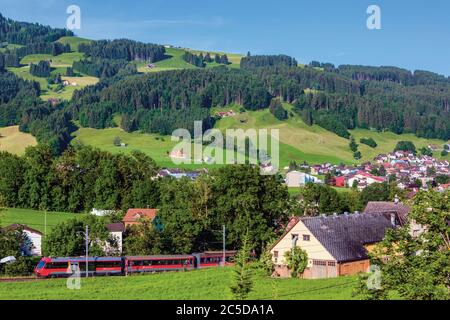 Appenzell, Appenzell Innerrhoden Canton, Svizzera. Periferia della città e campagna oltre. Le Ferrovie svizzere si allenano in primo piano. Foto Stock