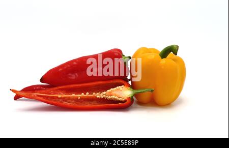 Composizione di diversi peperoni dolci e delle loro metà di colori diversi su uno sfondo chiaro. Prodotto naturale. Colore naturale. Primo piano. Foto Stock