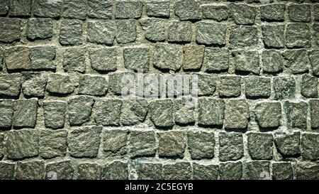 Fondo texture pavimentazione cobblestone. Vista dall'alto della strada in pietra. Dettaglio del marciapiede in granito preso dall'alto. Vecchie strade acciottolate per sfondo. AB Foto Stock