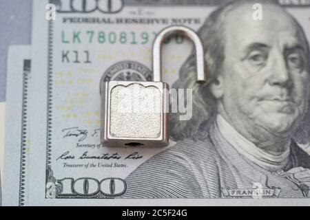 Aperto blocco di sicurezza, aprire lucchetto in background dollaro fattura . Concetto di protezione del denaro. Violazione della sicurezza bancaria Foto Stock