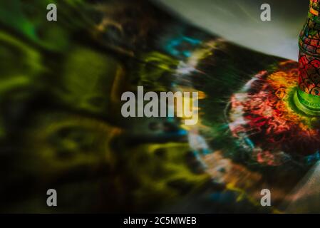 luce che passa attraverso una bottiglia con arte colorata Foto Stock