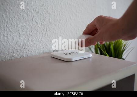 Cuffie wireless prelevate dal pad di ricarica wireless Foto Stock
