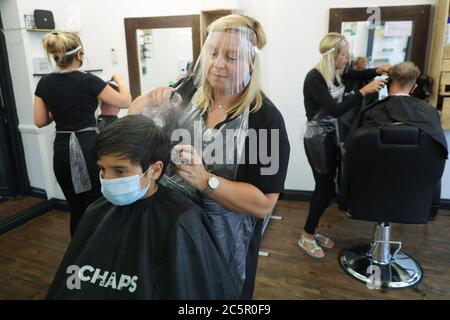 Winchester, Gran Bretagna. 4 luglio 2020. La gente ha i loro capelli tagliati a Chaps Barbershop a Winchester, Gran Bretagna, il 4 luglio 2020. Milioni di persone in Inghilterra sono emerse dal blocco COVID-19 del cosiddetto "Super Saturday" per godersi caffè, bar, ristoranti e saloni per capelli per la prima volta in più di tre mesi. Credit: Tim Ireland/Xinhua/Alamy Live News Foto Stock