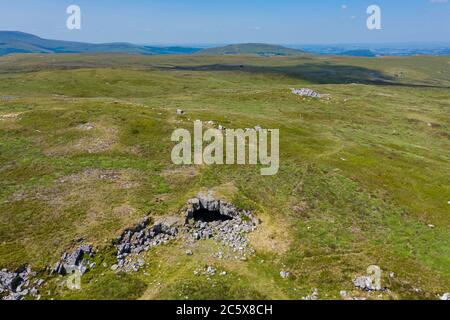 Vista aerea dell'ingresso di un sistema di grotte sotterranee sulla remota brughiera (Chartist Cave, Galles, Regno Unito) Foto Stock