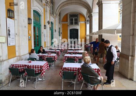 LISBONA, PORTOGALLO - 4 GIUGNO 2018: La gente visita i portici ombreggiati di Piazza Comercio (Praca Comercio) a Lisbona, Portogallo. Lisbona è l'11° più popoloso Foto Stock