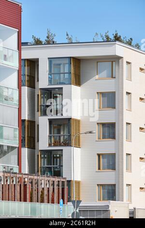 Il nuovissimo edificio di appartamenti in giornata di sole a Joensuu, Finlandia. Moderna architettura finlandese. La facciata bianca in legno dell'edificio. Foto Stock