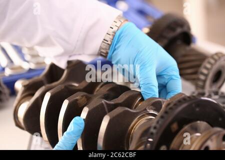 Mani maschili che tengono un pezzo di ricambio da un'auto Foto Stock