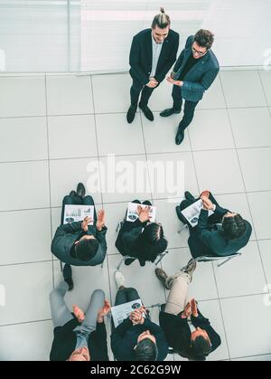 vista dall'alto. team aziendale che si congratula con il miglior dipendente. Foto Stock