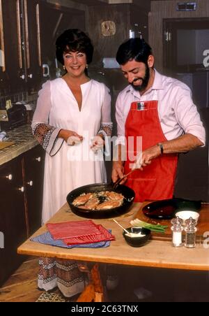 Elizabeth Taylor riceve una lezione di cucina dallo chef Nick Grippo nella sua casa Bel Air. Foto Stock