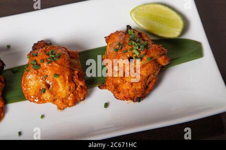 Filetto di pollo speziato, marinato in stile rustico con yogurt speziato e arrostito in tandoor. Immagine isolata. Foto Stock