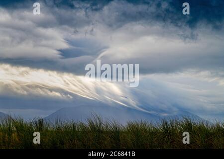 Nuvole tempesta e erba sulle dune di Inch Beach sulla penisola di Dingle, Inch, County Kerry, Irlanda Foto Stock
