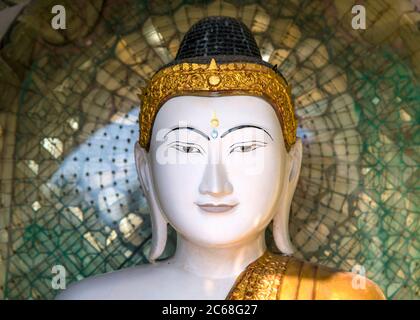 Vista ravvicinata della faccia di una statua di Buddha nella Pagoda di Shwedagon, Yangon, Myanmar Foto Stock