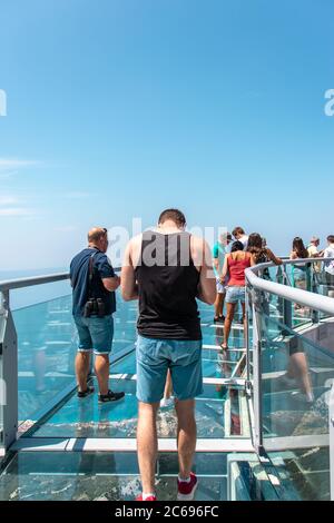 I turisti camminano attraverso il nuovo Skywalk sulla montagna di Biokovo. Immagine verticale vista dalla struttura in vetro Foto Stock