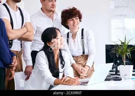 Lavoro di successo del team internazionale in carica, riuniti per discutere nuove idee, guardando lato ascoltare allenatore Foto Stock