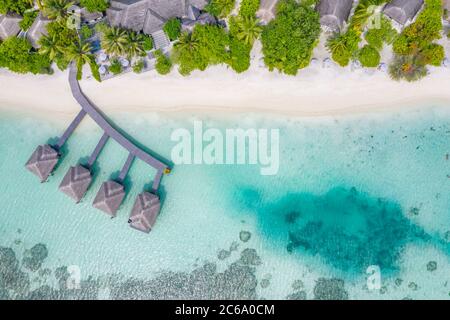 Perfetto paesaggio aereo, resort tropicale di lusso o hotel con ville sull'acqua e splendidi paesaggi sulla spiaggia. Incredibile vista degli occhi di uccelli nelle Maldive, paesaggio Foto Stock