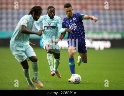 Antonee Robinson di Wigan Athletic (a destra) e Olamide Shodipo (centro) di Queens Park Rangers combattono per la palla durante la partita del campionato Sky Bet allo stadio DW di Wigan. Foto Stock