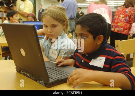 Austin, Texas USA, 19 aprile 2005: I bambini di seconda elementare guardano il programma di sicurezza Internet per bambini sui computer portatili della biblioteca scolastica durante l'evento di avvio per il "Cyber-Guardian for the Internet Age: Faux Paw the Techno Cat." ©Bob Daemmrich Foto Stock