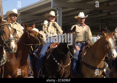 Eagle Pass Texas USA, marzo 2005: Il senatore statunitense Kay Bailey Hutchison of Texas cavalca con cavalieri locali attraverso il ponte internazionale sul fiume Rio grande da Eagle Pass a Piedras Negras in Messico. La corsa fa parte del suo tour che promuove il nuovo El Camino Real National Historic Trail. ©Bob Daemmrich Foto Stock