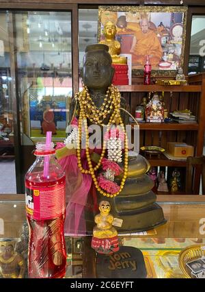 Thailandia. 23 Giugno 2020. Una bottiglia di limonata si trova come offerta nel tempio Wat Sanngam di fronte a una figura di Kuman Thong che dovrebbe contenere ceneri con resti umani. I feti originariamente morti o parti di bambini morti sono stati mescolati nelle figure. Tuttavia, una legge degli anni '70 vieta la dissacrazione dei cadaveri e quindi questo metodo di produzione. Nel frattempo, altre parti di cadaveri vengono utilizzate anche per la produzione - anche di adulti morti. Credit: Kawewit Kaewjinda/dpa/Alamy Live News Foto Stock