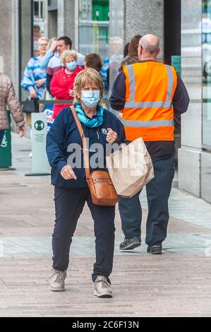 Cork, Irlanda. 9 luglio 2020. Una donna indossa una maschera facciale nella città di Cork per proteggersi dal Covid-19. Credit: Notizie dal vivo di AG/Alamy Foto Stock