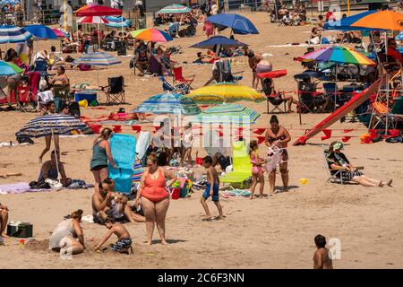 Migliaia di beachgoers osservano generalmente le distanze sociali mentre cercano di battere il calore e l'umidità a Coney Island a Brooklyn a New York nel fine settimana lungo di giorno di Indipendenza, domenica 5 luglio 2019. (© Richard B. Levine) Foto Stock