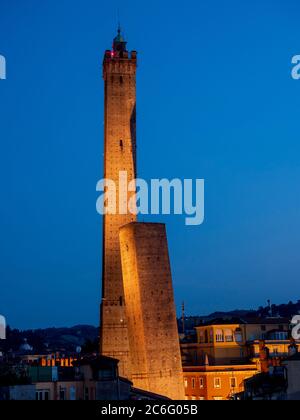 Torre Asinelli e il suo vicino più corto, la Torre Garisenda. Illuminato di notte. Bologna, Italia. Foto Stock