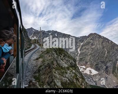 Chamonix, Chamonix Mont Blanc, Francia. 10 luglio 2020. I passeggeri mascherati a bordo della funivia del Monte Bianco ammirano le attrazioni turistiche mentre il treno a ingranaggi di montagna si snoda sulle montagne lungo la strada per Nid d'Aigle vicino al ghiacciaio Bionnassay. Credit: Sachelle Babbar/ZUMA Wire/Alamy Live News Foto Stock