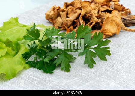 funghi secchi, lattuga e verdi su un tovagliolo di tela. concetto di alimentazione sano Foto Stock