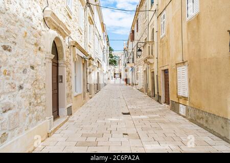 Croazia, bella vecchia strada acciottolata, case tradizionali e nel centro storico di Pag Foto Stock