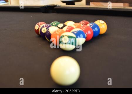 Tavolo da biliardo nero, biliardo da gioco 8ball - primo piano di un uomo che gioca a biliardo Foto Stock