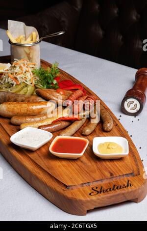 Salsicce alla griglia e verdure sottaceto con spuntini alla birra Foto Stock