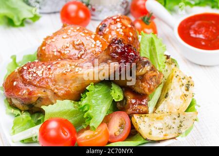 Cosce di pollo fritte con salsa teriyaki e semi di sesamo Foto Stock