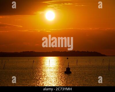 Tramonto su Whitstable, Kent, Regno Unito, guardando verso l'isola di Sheppey Foto Stock