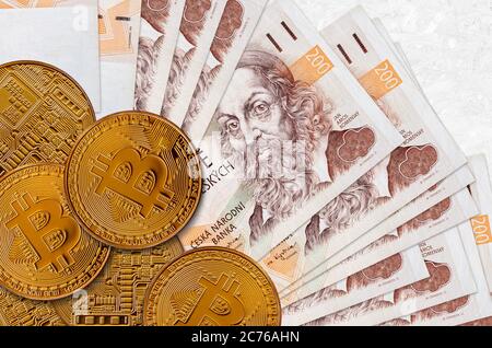 200 bollette ceche e monete d'oro. Concetto di investimento in criptovaluta. Crypto mining o transazioni commerciali Foto Stock