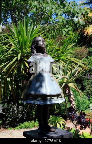 Una statua di Alice nel paese delle meraviglie nei giardini subtropicali Abbotsbury a Dorset, Inghilterra Foto Stock