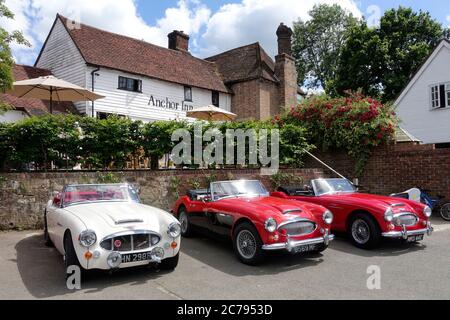 Primo piano di 3 Austin Healey Mark III parcheggiati fuori da una casa pubblica inglese in un giorno estivo Foto Stock