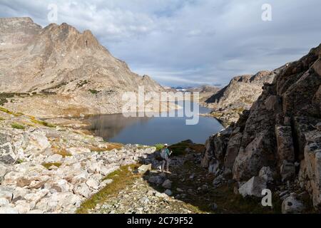 Una saccopelatrice femminile si avvicina all'estremità meridionale del lago Long (10147 USFS Map) nella Wind River Range del Wyoming. Foto Stock