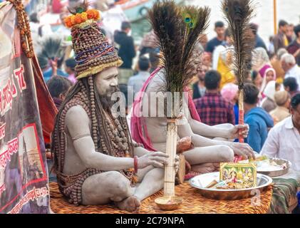 Un Naga Sadhu si siede di fronte alla sua tenda a. I ghat Varanasi Foto Stock