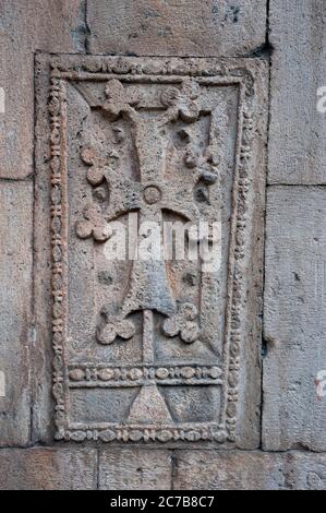 Una croce scolpita nella pietra di Geghard, un monastero medievale parzialmente scolpito dalla montagna adiacente nella provincia di Kotayk vicino a Yerevan, Arme Foto Stock