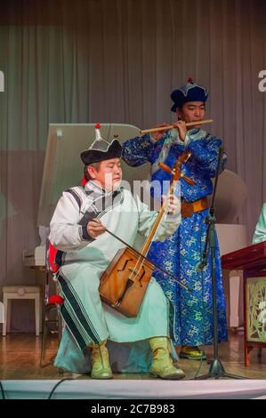 Un musicista mongolo sta suonando il Morin khuur, conosciuto anche come crine head fiddle, un tradizionale strumento mongolo a piego, durante un culturale Foto Stock