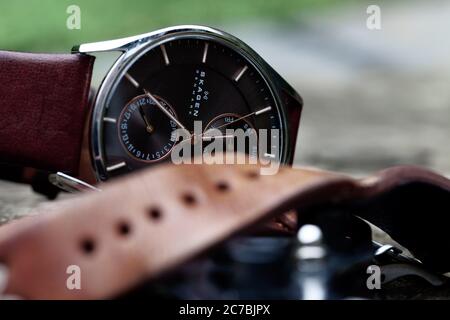 Primo piano di un orologio su un'orologa o guaritori panchina. Un bel primo piano su macro, che mostra i dettagli e la natura intricata di un orologio da polso. Foto Stock