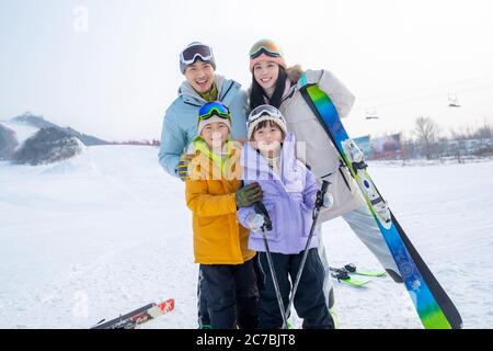 Felici le famiglie giovani a giocare stazione sciistica Foto Stock