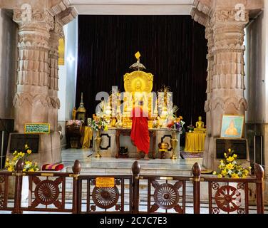 Ampio shot di statua dorata del Buddha nell'altare all'interno del Mulagandha Kuti Vihara a Varanasi, India Foto Stock